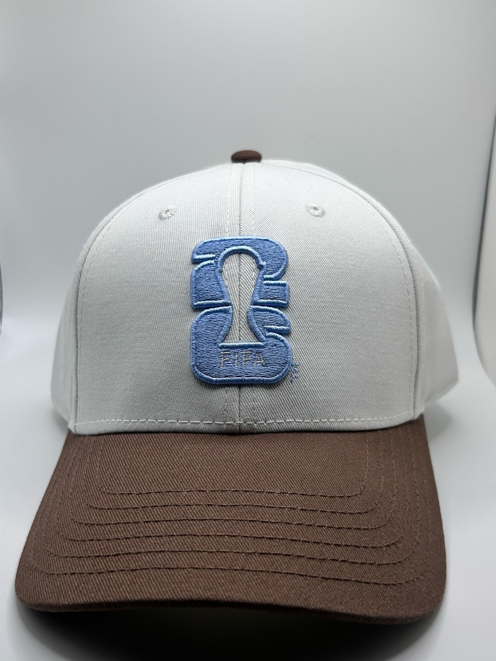 Brand new White and Brown Baseball Cap with Light Blue Embroidery